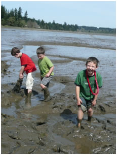 children playing in beach mud